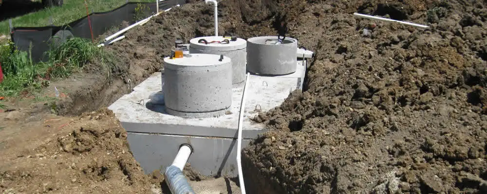 Septic system repair and installation site with tank access ports in Omaha, NE